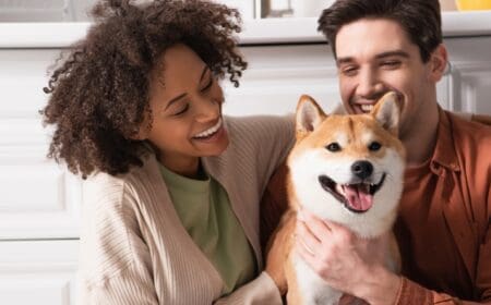 man and woman hugging a dog