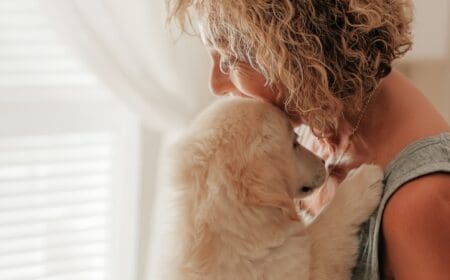 A woman hugging her golden retriever, one of the best emotional support dog breeds.