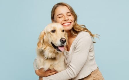 Young happy woman hugging a dog.