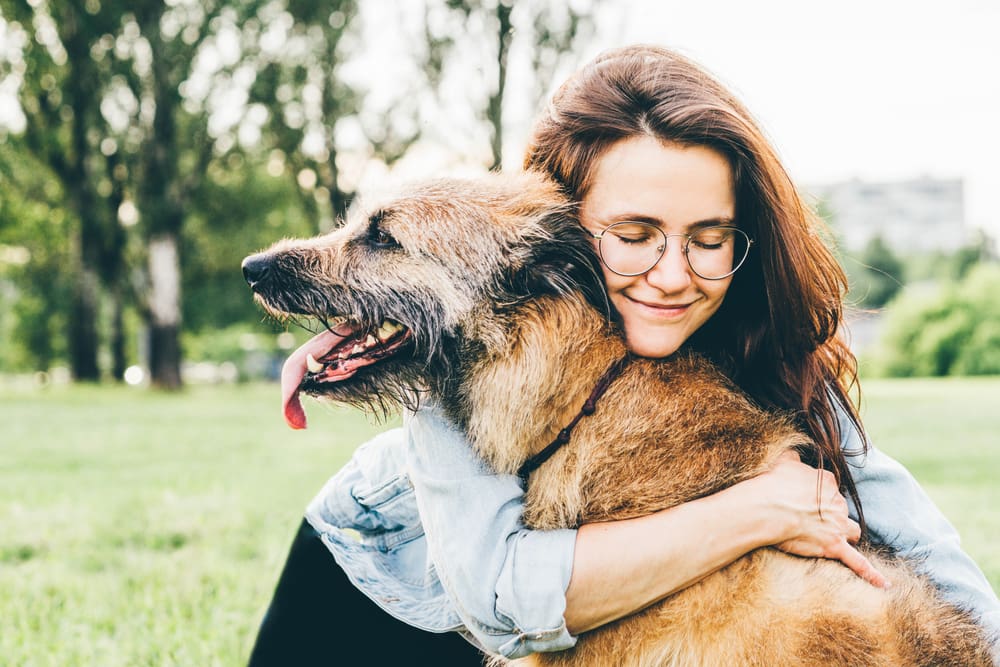 woman hugging dog