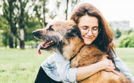 woman hugging dog