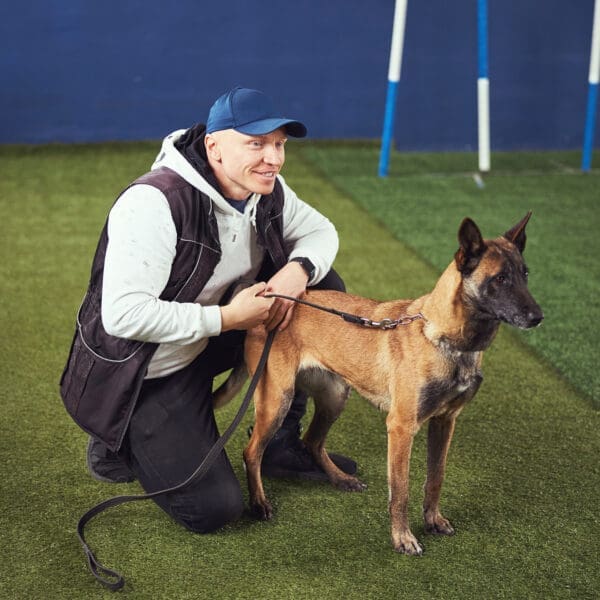 happy trainer with dog at gym