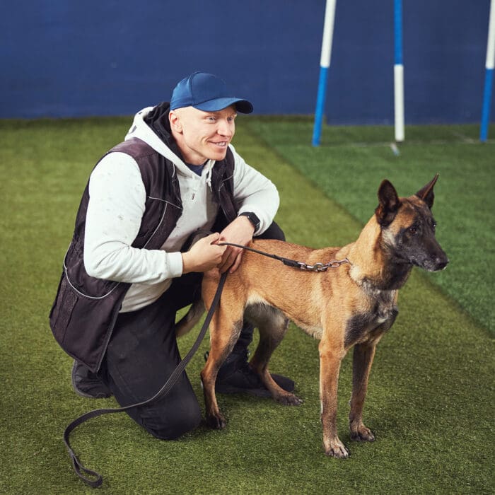 happy trainer with dog at gym happy trainer with dog at gym